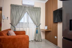 a living room with a couch and a window at Sycamon Suites in Jwaneng