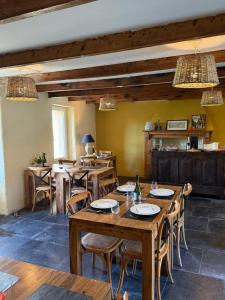 a dining room with wooden tables and chairs at Chez Les Hollandais in Roscanvel