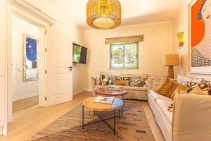 a living room with a couch and a table at Villa Arta by Hostiva in Comporta