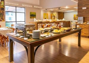 a table with food on it in a kitchen at Dexter Hotel - Volta Redonda in Volta Redonda