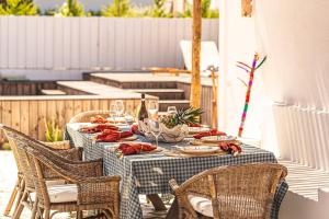 a table with a table cloth on a patio at Villa Arta by Hostiva in Comporta