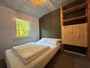 a bedroom with a bed and a bunk bed at Boslodge 7 personen in Tiendeveen