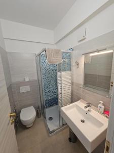 a bathroom with a sink and a toilet and a shower at Country House Andromeda in Offida +32 photos