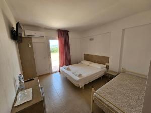 a hotel room with a bed and a window at Country House Andromeda in Offida