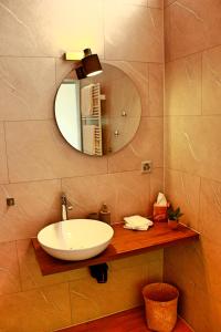 a bathroom with a sink and a mirror at La Boutique in Saignelégier
