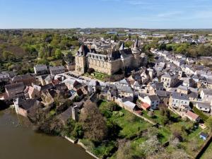 an aerial view of a town with a castle and a river at Chateau de Durtal in Durtal +17 photos