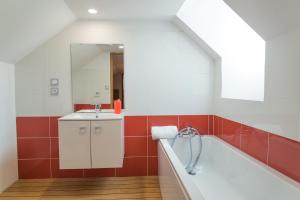 a bathroom with a bath tub and a sink at L'etable de pierre in Nojaret +32 photos