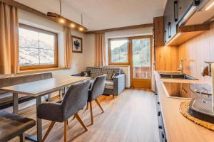 a kitchen and dining room with a table and chairs at Appartements Kaltenbach in Kaltenbach