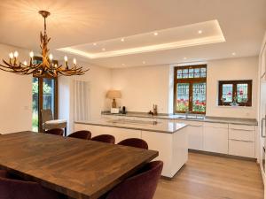 a kitchen and dining room with a table and chairs at Villa Flora 1909 - Private Alpine Residence in Grindelwald