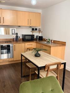 a kitchen with a table and chairs in a kitchen at Cozy One bedroom with Free Underground parking in Mailbox Birmingham city in Birmingham