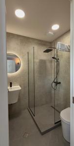 a bathroom with a shower and a toilet and a sink at Oli Home in Kazbegi