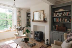 a living room with a fireplace and a table at The Roost in Westport