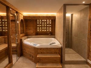 a large bathroom with a tub and a shower at Villa Flora 1909 - Private Alpine Residence in Grindelwald +36 photos