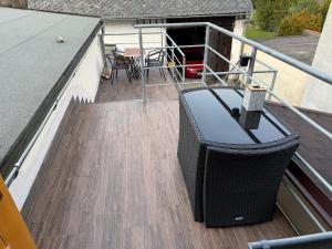 a balcony with a television and a table on a roof at Penzion Hedvika in Kravaře