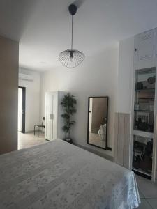 a bedroom with a large bed and a mirror at Il Pulo Guest House in Molfetta