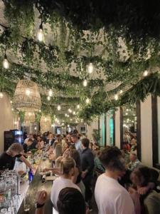 a crowd of people sitting at a bar in a restaurant at Hotel Fuchs in Saarbrücken