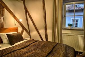 a bedroom with a large bed and a window at Hotel Fuchs in Saarbrücken
