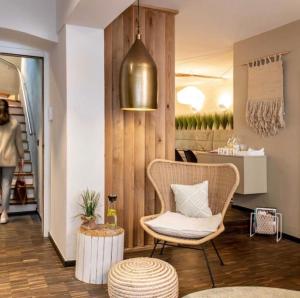 a living room with a chair and a table at Hotel Fuchs in Saarbrücken