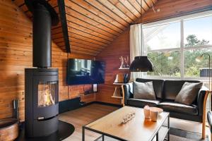 a living room with a fireplace and a couch at BV422-Blavand-Hedetoftvej-2 in Blåvand