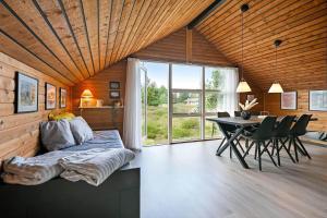 a bedroom with a bed and a table with chairs at BV422-Blavand-Hedetoftvej-2 in Blåvand