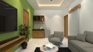 a living room with a couch and a tv at SUITE ROOMS Sarjapur Road Near to HSR Layout in Bangalore