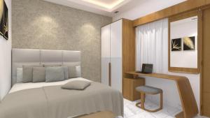 a bedroom with a bed and a chair and a mirror at SUITE ROOMS Sarjapur Road Near to HSR Layout in Bangalore