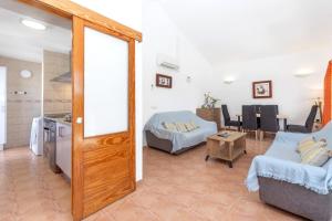 a living room with a couch and a table at Villa Jaume in Cala en Bosc