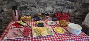 a picnic table with cheese and other foods on it at Penzion-Na Navsi in Horní Planá