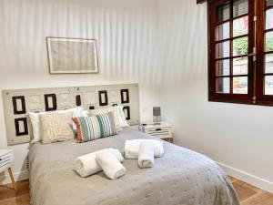 a bedroom with a large bed with towels on it at Villa Hermida in Sanxenxo