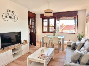 a living room with a couch and a table at Villa Hermida in Sanxenxo