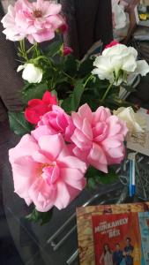 a vase of pink and white flowers on a table at RELAXViLLA MISKOLCTAPOLCA in Miskolc
