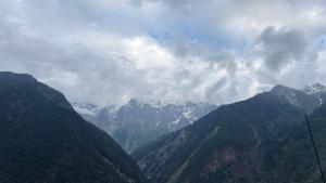 a view of a mountain range with snow capped mountains at The Raulane Homestay in Kalpa