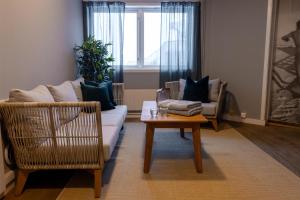 a living room with a couch and a coffee table at Radisson Blu Polar Hotel, Spitsbergen in Longyearbyen