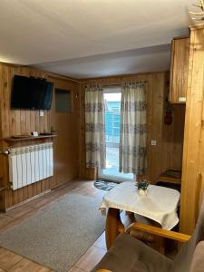 a living room with a table and a window at Agroturystyka Stajnia Bukwica in Narewka