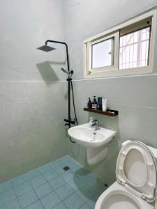 a bathroom with a white toilet and a sink at 小仙肉包棟民宿 in Miaoli +26 photos