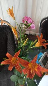 a vase of flowers sitting on a table at RELAXViLLA MISKOLCTAPOLCA in Miskolc