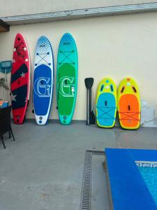a group of surfboards are lined up against a wall at White House Chakvi in Chakvi +173 photos