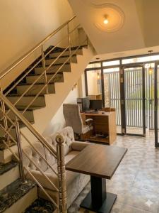 an office with a staircase with a desk and a table at Baloon Rooms Taramandal in Gorakhpur