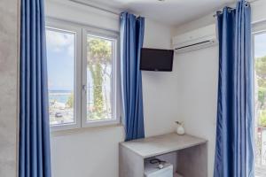 a room with blue drapes and a window at Casamicciola Rooms in Casamicciola Terme +96 photos