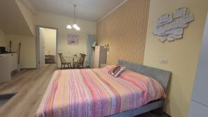 a bedroom with a bed and a kitchen and a table at MoMa Home Villasanta Monza Park in Villasanta
