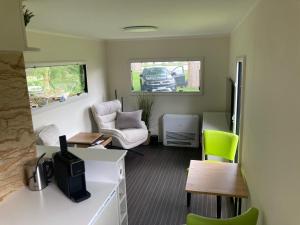 a living room with a car parked in a garage at TinyHouse am Stadthafen in Hennigsdorf