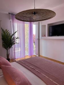 a bedroom with a large bed and a large window at Guest House Mijo Sokol in Brela