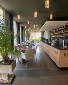 a restaurant with tables and chairs and a counter at Hotel Olympia in Kopřivnice