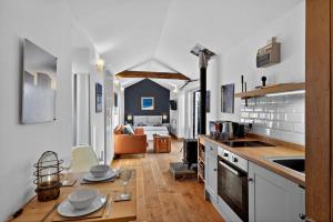 a kitchen with a table and a living room at 1 Bed in Belford oc-cn002 in Lucker