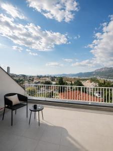 a balcony with a view of a city at AAA Luxury Suites Split with Pool in Split