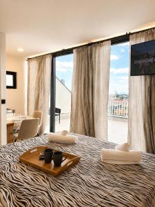 a hotel room with a tray of food on a bed at AAA Luxury Suites Split with Pool in Split