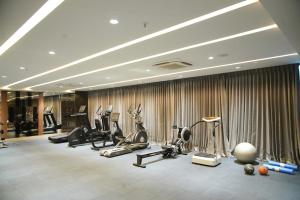 a gym with several treadmills and exercise bikes at Hotel Shubham Celebrations-Miyapur in Lingampalli