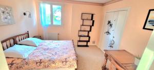 a bedroom with a bed and a window at Bolumet in Neulliac +2 photos