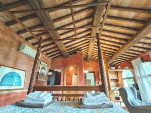 a bedroom with a wooden ceiling with wooden beams at Residenza termale Monte Santo in San Casciano dei Bagni