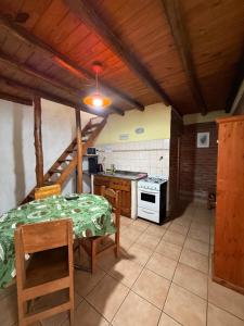 a kitchen with a table and a stove top oven at Cabañas Las Marias in San Luis